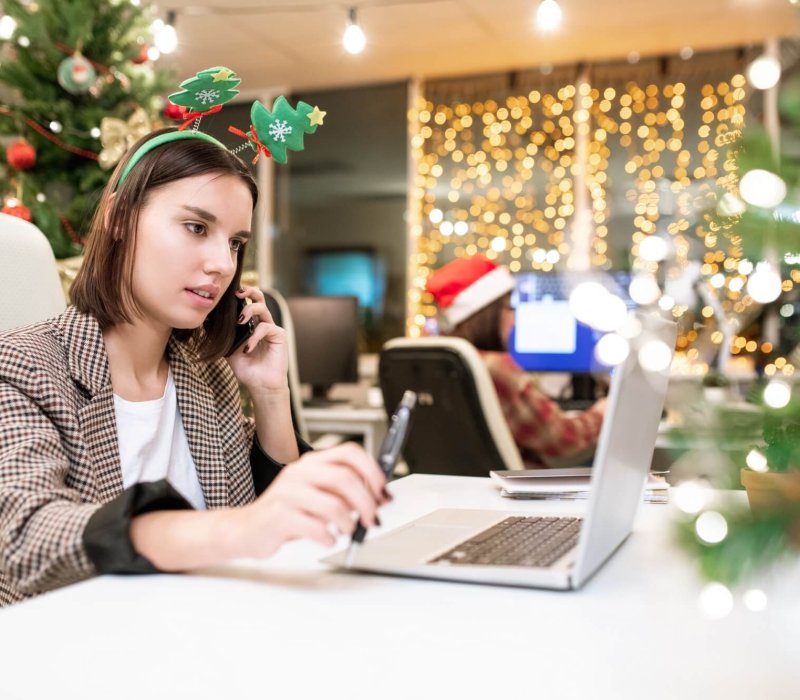 Young contemporary businesswoman with mobile phone organizing work in office